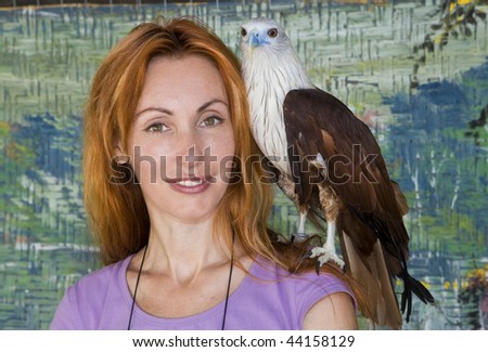 Portrait of young woman with bird shoulder arm