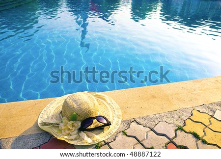 The straw hat lies on the brink of pool