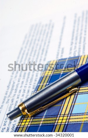 the pen and notebook on the text background
