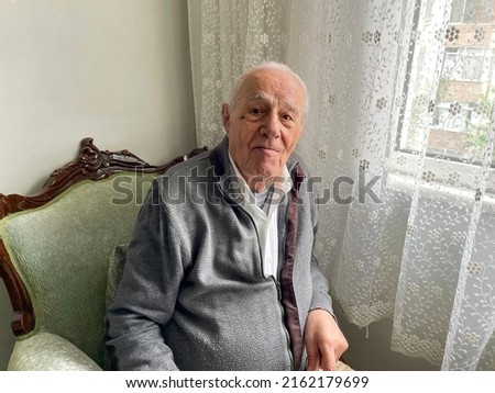 Image, Stock Photo Portrait of very old farmer with straw hat explaining life in front of a red tractor.