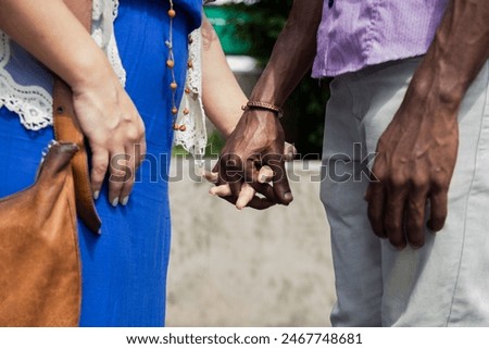 Similar – Image, Stock Photo Romantic multiethnic couple holding hands and strolling along city street