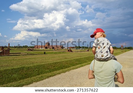 KRAKOW, POLAND - JULY 14th 2014: A child looks back on the field concentration Auschwitz in Poland