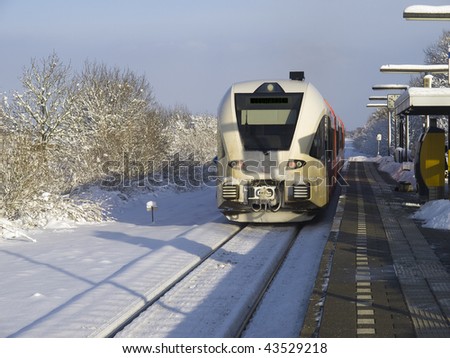 Train coming into the railway station with snow