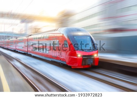 High speed double decker express train arrives at a station in the city