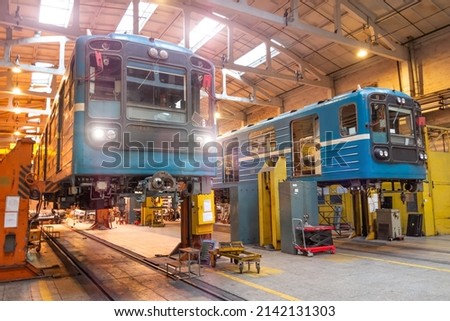 Passenger locomotives of the underground metro raised on jacks with headlights on in the depot, maintenance and replacement of engines and wheelsets, bogies ストックフォト © 