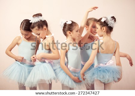 Group of five little ballerinas posing together and practicing for performance. They are good friend and amazing dance performers