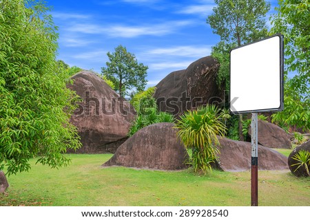 blank billboard in garden stone emerged  of ground.