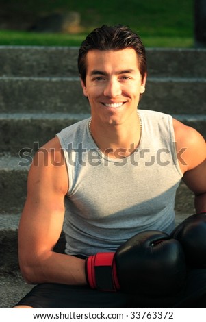 A boxer sitting on steps with his gloves on