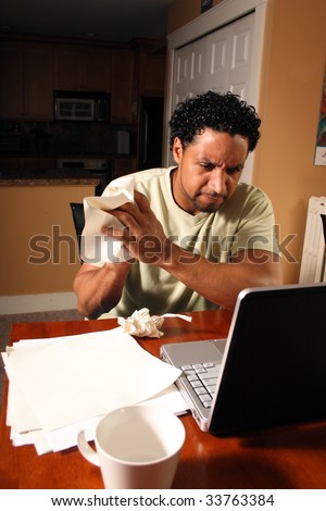 A man crumpling a piece of paper to start his work over