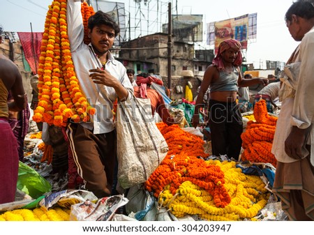 CALCUTTA, INDIA - NOVEMBER 20, 2014: Indian merchants selling bunches of marigolds. Flower market, Kolkata, India.