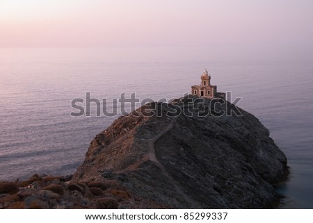 A stone lighthouse at dusk