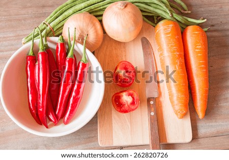 Image of a wood cutting board with assorted vegetables