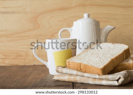 Coffee and bread on wooden background