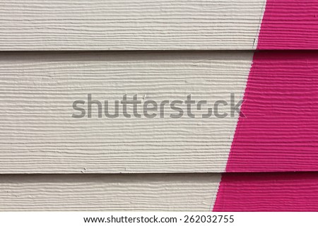 White and pink painted wood on a small house across from the ocean, nice texture and background, Tierra del Fuego
