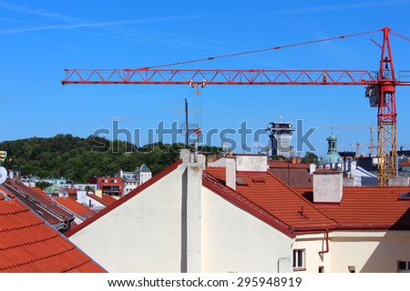 Rooftops with crane construction, park and blue sky in the background, Prague, Czech Republic, Europe