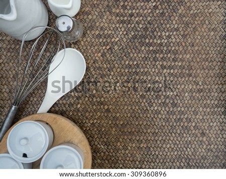 Kitchen tools border on the basketwork background