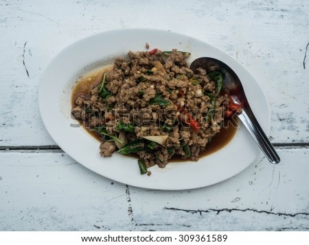 Thai food call Pad Kra Pow (Holy Thai Basil) and spoon