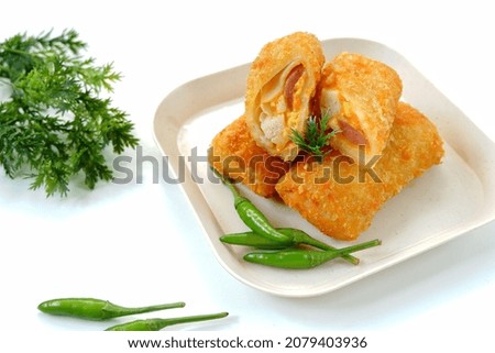 Selective focus risoles sosis mayo (American risoles) or mayonnaise sausage rissole is a small patty rolled in breadcrumbs. it is filled with mayonnaise, boiled egg and sausage. Served on white plate. Zdjęcia stock © 