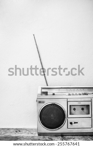 Vintage radio on the table front of the wall black and white picture