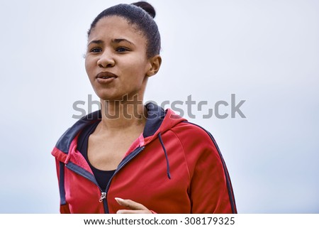 Determined young woman busy training for her long distance running