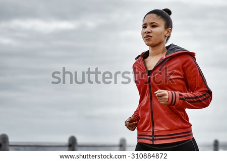 Woman busy jogging along the ocean side in the morning to keep active and always keep moving forward