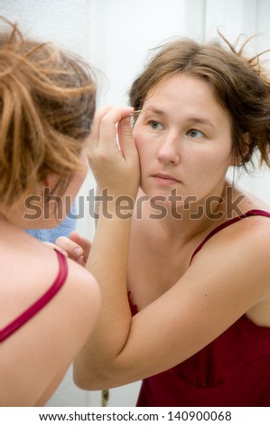 portrait of attractive  woman making her make-up