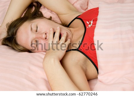 portrait of yawning woman in bed