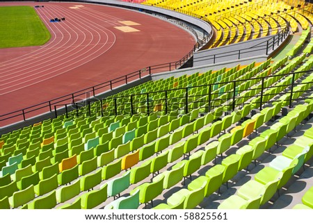 A field of empty seats in a open stadium in china outdoor.