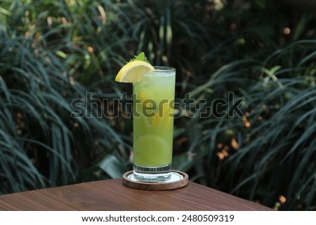 Similar – Image, Stock Photo Lemonade glass with cucumber and lime. Summer cocktail