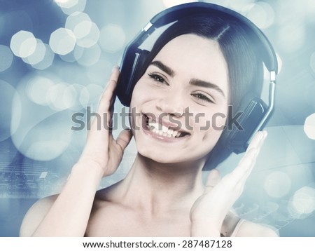 Beauty young girl hearing music with headset, female portrait