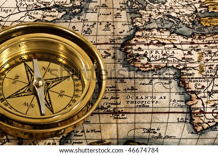 Adventure still life with retro navy compass and map