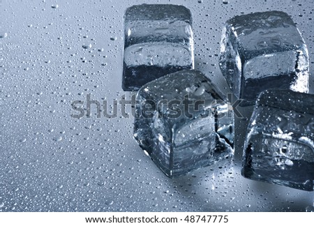 Ice cube and water drops on the wet background