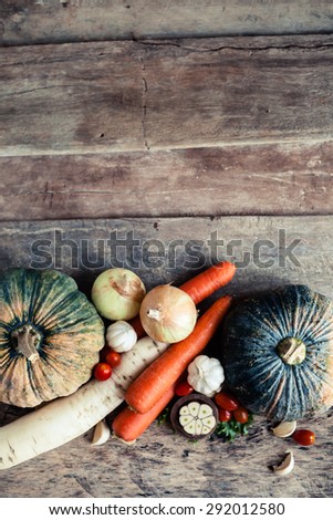 Farm market photo with different vegetables and greens - view from the top. Organic products and healthy lifestyle photography. Fresh food on the wooden background.