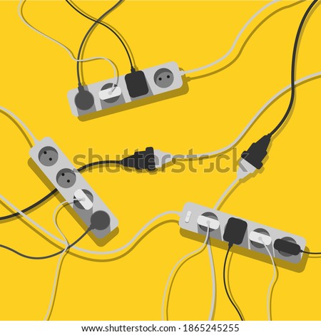 A mess of cables from several extension cords, electrical wires and chargers on a yellow background. Cable clutter. Cable management. 