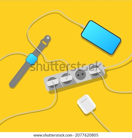 Smartphone, smart watch, wireless headphones are charging. A mess of cables from an extension cord, electrical wires, chargers and electronic gadgets on a yellow background. Cable management.