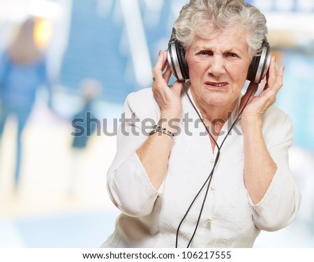 portrait of a senior woman listening to music indoor