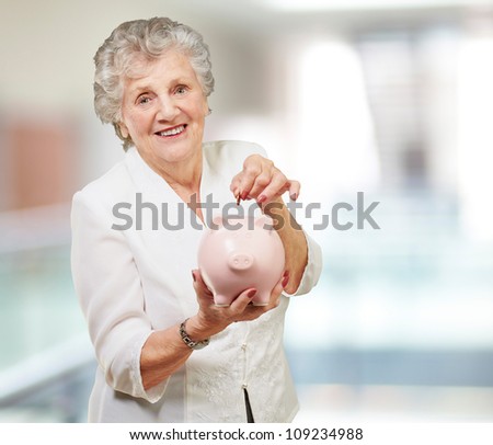 Portrait Of A Mature Woman With A Piggy Bank, Indoor