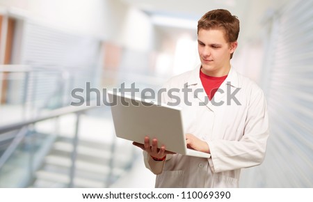 Portrait of a doctor surfing on laptop, indoor