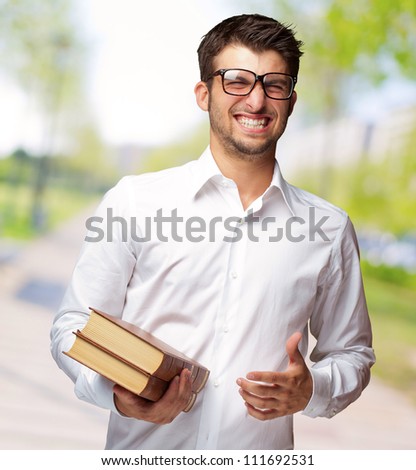 Portrait Of A Student Holding Book, Outdoor