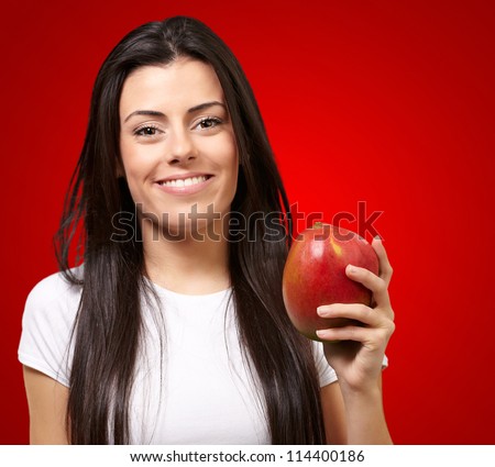 A Young Woman Holding A Mango On Red Background