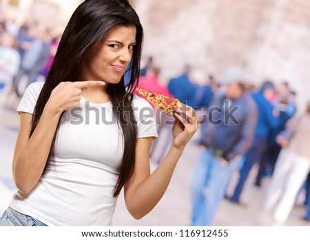 Portrait Of A Young Woman Eating A Piece Of Pizza, Outdoor