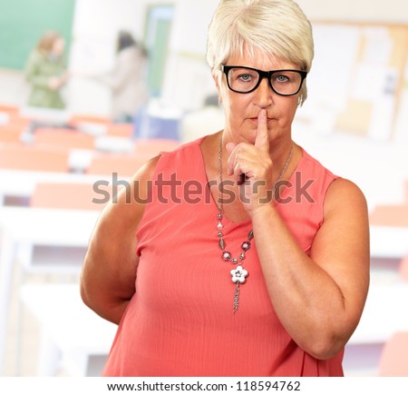 Senior Woman With Finger On Lips, Indoor