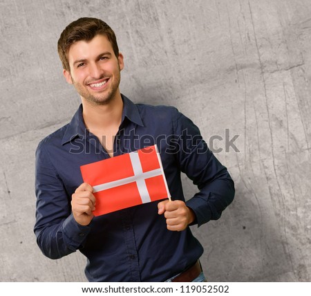 Portrait of a young man holding flag, indoor