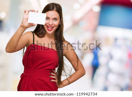Happy Young Woman Holding Blank Placard against an abstract background