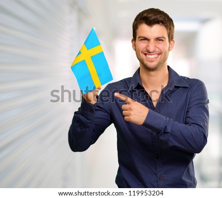 Portrait of a man holding flag, indoor