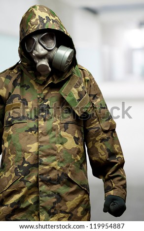 angry soldier wearing a gas mask, indoor