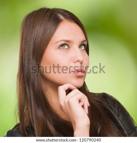 Portrait Of A Young Confused Woman against a nature background