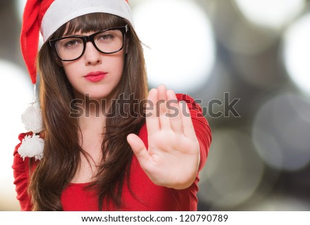 christmas woman doing a stop gesture against an abstract background
