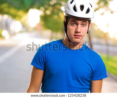 Young Man Wearing Bike Helmet at a park