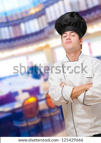 Portrait Of A Funny Chef With Hands Folded at a restaurant